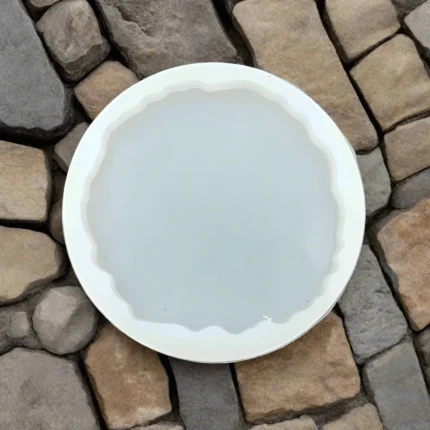 Round white plate on stone surface